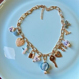 Cute and Fun Gold Toned Necklace with Blue, White, and Gold Charms